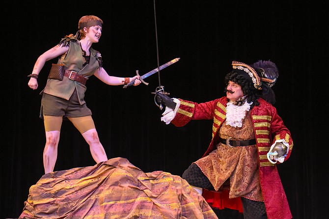 Peter Pan (Katie Emerson) and Captain Hook (David Spencer) sword fight in New Stage Theatre’s production of “Peter Pan.” Photo courtesy New Stage Theatre