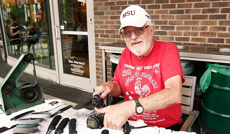 Jim Burwell, who owns Burwell Blades, has set up many Saturdays outside of Whole Foods Market to sharpen blades for people.