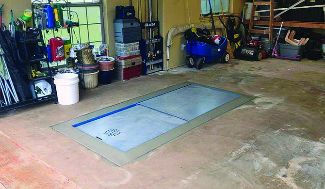 Torshel can install an underground storm shelter inside a customer's garage. Photo courtesy Torshel Storm Shelters