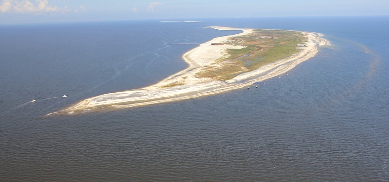 To educate and spur action, the National Park Service has notably shifted its tone on climate change at parks including Gulf Island National Seashore on the Mississippi coast. Photo courtesy Karen Westphal, United States Geological Survey