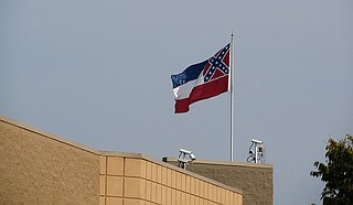 Mississippi state flag flies over a building in Tupelo, Miss. Photo courtesy Jim Lund/Flickr