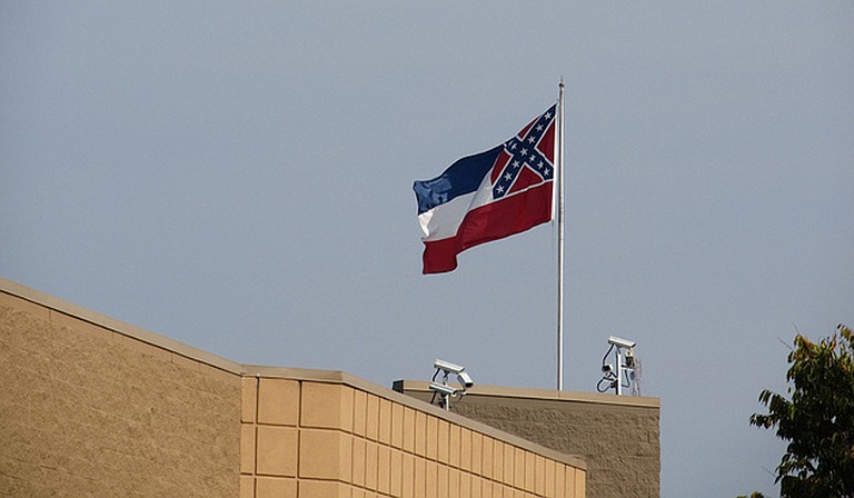 Mississippi state flag flies over a building in Tupelo, Miss. Photo courtesy Jim Lund/Flickr