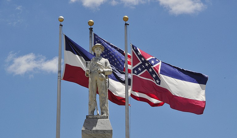A statue of a Confederate solder stands in the square in downtown Brandon in front of a Mississippi flag containing the controversial Confederate battle symbol. Photo courtesy Trip Burns/File Photo