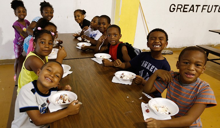 Six-year-olds in the Boys and Girls Club summer program eat ice cream courtesy of The Phoenix Club.