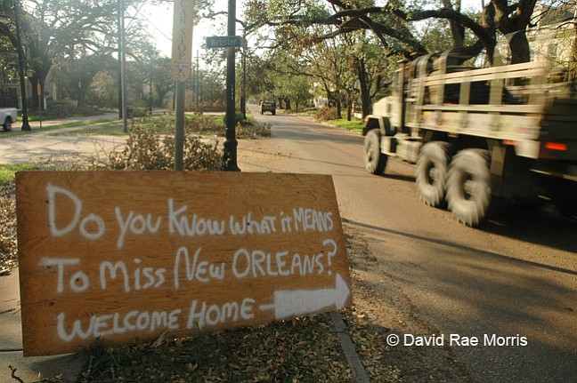 A military convoy drives  along St. Charles Avenue in Uptown New Orleans, Sept. 8, 2005.  The city was devastated when the levees broke after Hurricane Katrina made landfall in southeast Louisiana, flooding 80 percent of the city. Photo courtesy David Rae Morris