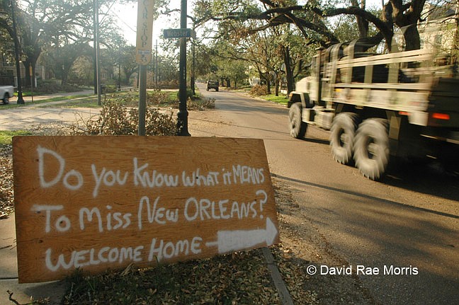 A military convoy drives  along St. Charles Avenue in Uptown New Orleans, Sept. 8, 2005.  The city was devastated when the levees broke after Hurricane Katrina made landfall in southeast Louisiana, flooding 80 percent of the city. Photo courtesy David Rae Morris
