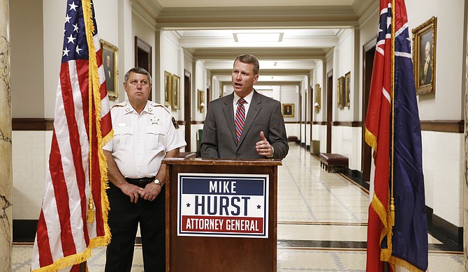At a Capitol press conference, Mike Hurst (right) and Simpson County Sheriff Ken Lewis (left) said Jim Hood's office interfered in the prosecution of former Mendenhall Police Chief Bruce Barlow.