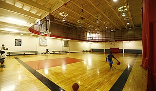 A young man shoots a basketball on a recent day at the downtown Jackson YMCA. The courts will soon be gone.