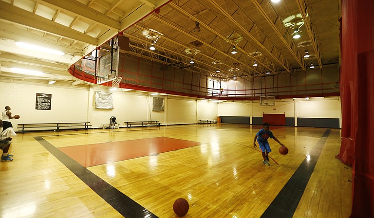 A young man shoots a basketball on a recent day at the downtown Jackson YMCA. The courts will soon be gone.