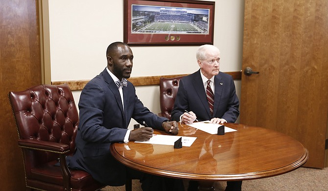 Jackson Mayor Tony Yarber (left) recently accepted $19.5 million from Mississippi Department of Transportation Commissioner Dick Hall (right) for infrastructure projects in Jackson, including those in the 1-percent sales tax master plan. Members of the Jackson City Council say constituents are already pressuring them to start spending the funds.