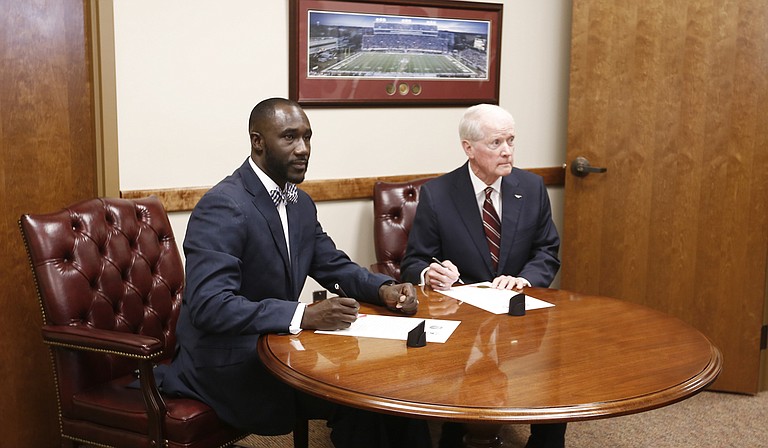 Jackson Mayor Tony Yarber (left) recently accepted $19.5 million from Mississippi Department of Transportation Commissioner Dick Hall (right) for infrastructure projects in Jackson, including those in the 1-percent sales tax master plan. Members of the Jackson City Council say constituents are already pressuring them to start spending the funds.