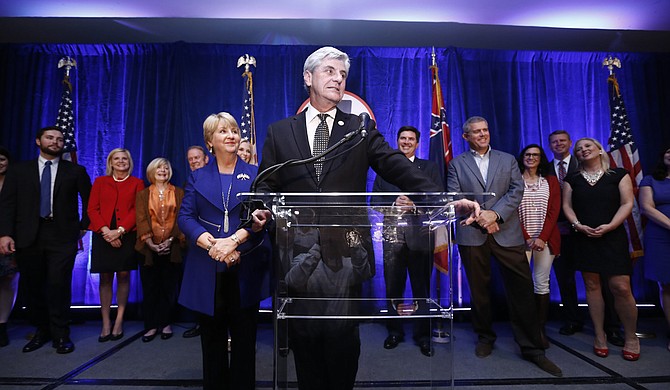 Gov. Phil Bryant, with his wife Deborah (left), addresses the crowd at the GOP election party, after the incumbent candidate easily defeated Democratic challenger Robert Gray to win a second-term as governor on Nov. 3.
