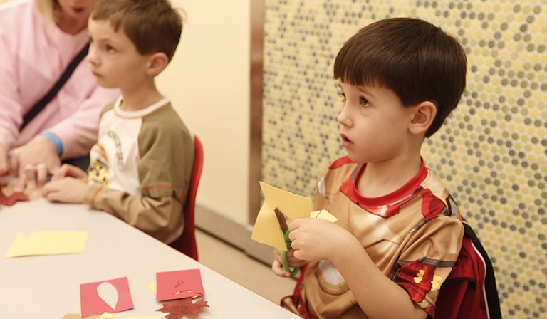 Owen Williamson (left) and Caleb Hinton (right) create paper turkeys on Nov. 25 at the “ABC, Come Play with Me” workshop at the Mississippi Children’s Museum.
