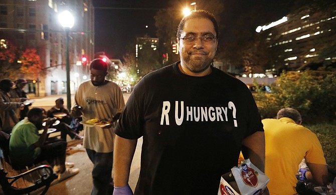 Bilal Qizilbash, 29, pulls together a group of volunteers to provide hot meals to homeless people every Friday at Smith Park.