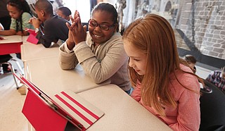 Quintaria Wright (left) and Avery Berg (right) work on a coding app called Lightbot during Eastside Elementary’s Hour of Code on Dec. 9.