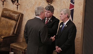 Gov. Phil Bryant (right) speaks with Speaker Philip Gunn (left), R-Clinton, and Speaker Pro Tem Greg Snowden (center), R-Meridian, after the dual-project bill passed through the House.