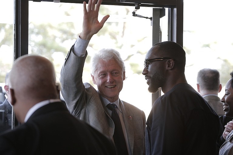 Former President Bill Clinton was greeted by Jackson Mayor Tony Yarber upon his arrival at Cups coffeehouse in Jackson's Fondren neighborhood.