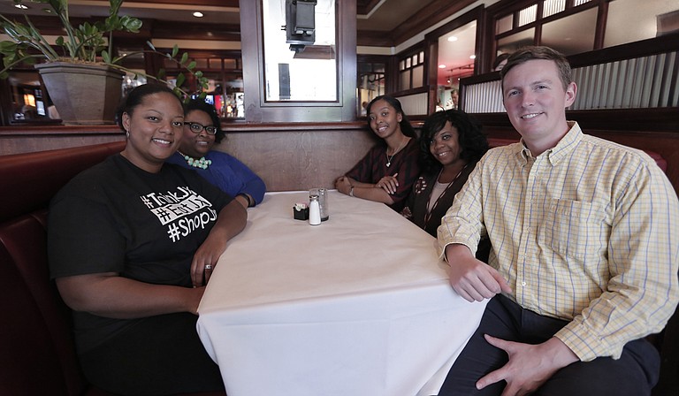 Carlyn Hicks (front left) founded JXN Foodies in 2015. She is pictured with Tiffany Paige (back left), Marlene Wright (back right), Marcia Keys (middle right) and Stephen Parks (front right).