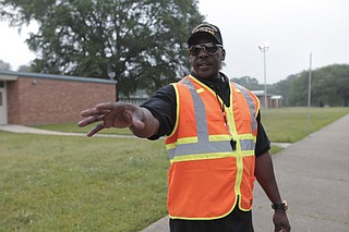 Sgt. Steve Collins, Jackson Public Schools Parent of the Year for 2016, helps McLeod Elementary School students in the carpool line.