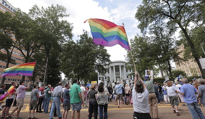 Hundreds of protesters marched from the Capitol to the governor's mansion on Sunday, calling on the state's leadership to repeal House Bill 1523.