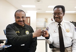 Jackson Police Chief Lee Vance (left) and Hinds County Sheriff Victor Mason fist-bump after the 2nd Precinct roll call as they talked on April 15 about Operation Side-by-Side that they were launching that night.
