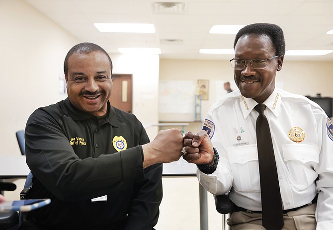 Jackson Police Chief Lee Vance (left) and Hinds County Sheriff Victor Mason fist-bump after the 2nd Precinct roll call as they talked on April 15 about Operation Side-by-Side that they were launching that night.