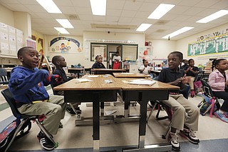 Galloway Elementary school students clap and spell words after school at Operation Shoestring.
