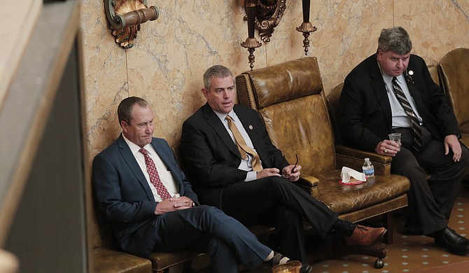 Rep. Herb Frierson, R-Poplarville, (left) House Speaker Philip Gunn (center) and Speaker Pro Tempore Greg Snowden, R-Meridian, (right) wait at the front of the House chamber, while a bill is read.