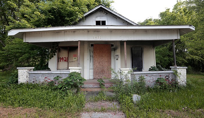 The Jackson Police Department has houses, such as this one in west Jackson, slated for demolition, as the house numbers spray-painted in red indicates.