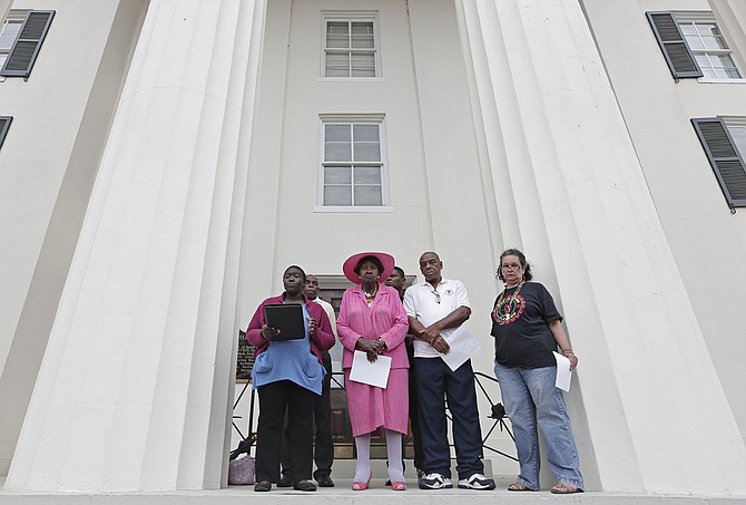 Members of the Coalition for Economic Justice, a local advocacy group, gathered on the steps of City Hall to protest "secrecy and division" in city government.