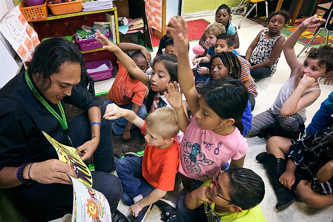 Luis Antonio Hernandez reads a story about Cinco de Mayo to students in Christy Crotwell’s first-grade class at Morton Elementary School. He reads each page twice, once in English, once in Spanish. He’s the only full-time translator at the school, which has 152 Spanish-speaking students in its 21 classrooms. Photo courtesy Ben Stocking