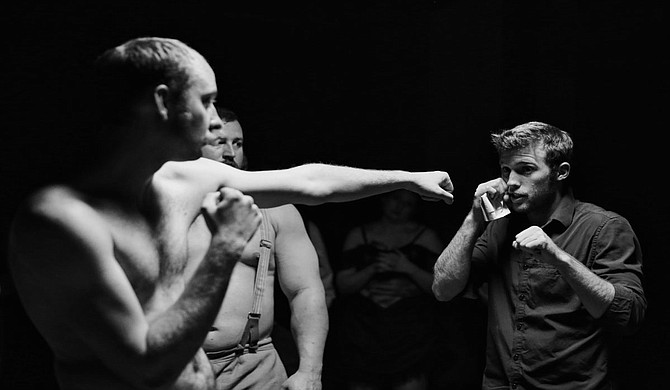 Joshua Powell (front left), who plays The Boxer in the film "Bare Knuckle," rehearses stunt choreography with the film's stunt coordinator, Jacob Pattison (right), as Lance Barrett (back left), who plays Bruiser in the film, looks on.