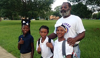 A Poindexter Elementary grandfather and WATCH D.O.G.S. member walks to school with his grandchildren. Photo courtesy Jackson Public Schools