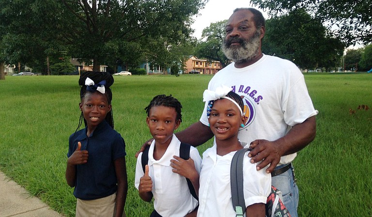 A Poindexter Elementary grandfather and WATCH D.O.G.S. member walks to school with his grandchildren. Photo courtesy Jackson Public Schools