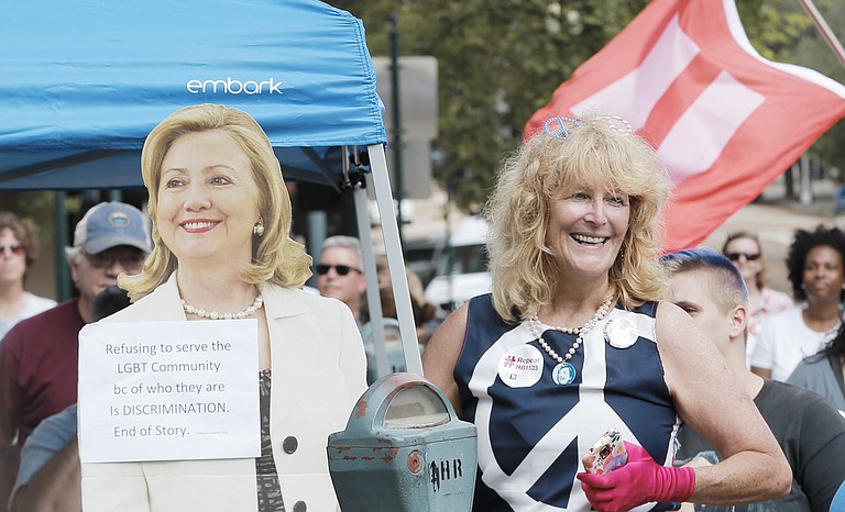 Kelly Jacobs (right) next to a cutout of Hillary Clinton at an LGBT rally in front of the governor's mansion in Jackson.