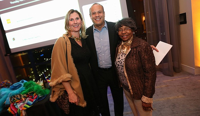 Tracy DeVries (left) with guests at a SMART party Photo courtesy Woman's Foundation