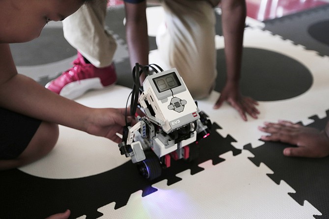 Students show off robots and other technology they helped build after school at Brown Elementary.