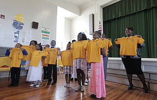 Watkins Elementary School students hold up their new spirit polo shirts.