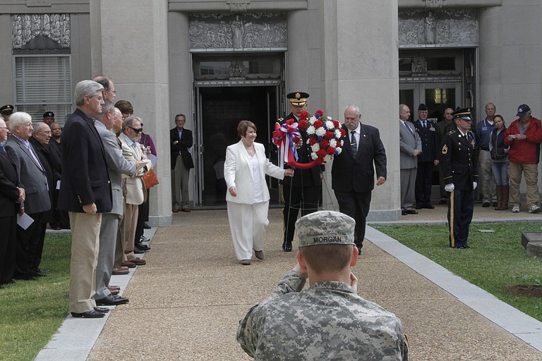 Gold Star parents Leonard and Sandra Scardino lay the wreath in honor of their son who died in service, as Gov. Phil Bryant and other leaders look on.