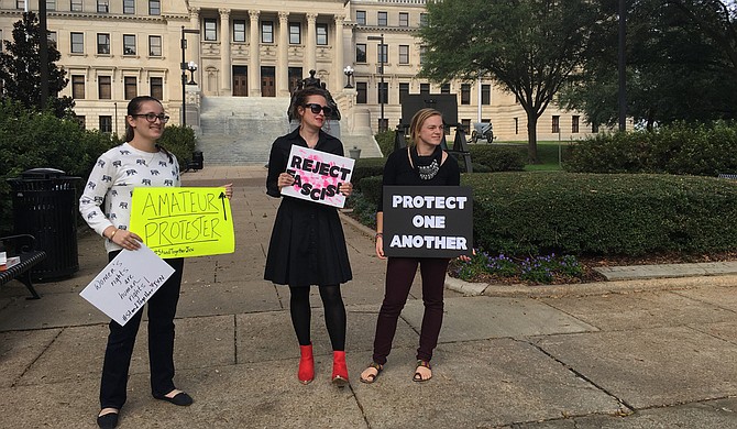 Rachel Glazer, Marisa Green and Karissa Bowley (left to right) protested outside the Mississippi Capitol Sunday, calling on Mississippians to stand together against hate.