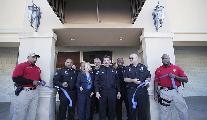 Officers and command staff gathered to celebrate the opening of a new Precinct 4 Headquarters at 5080 Parkway Drive. Pictured on the front row, from left, are Lt. Alfred Cooper, Deputy Chief James Davis, Pastor Terri Moore, Commander Keith Freeman, Assistant Chief Alan White and Officer Davi Coleman; District Commander James McGowan and Deputy Chief Joseph Wade are in the back row.