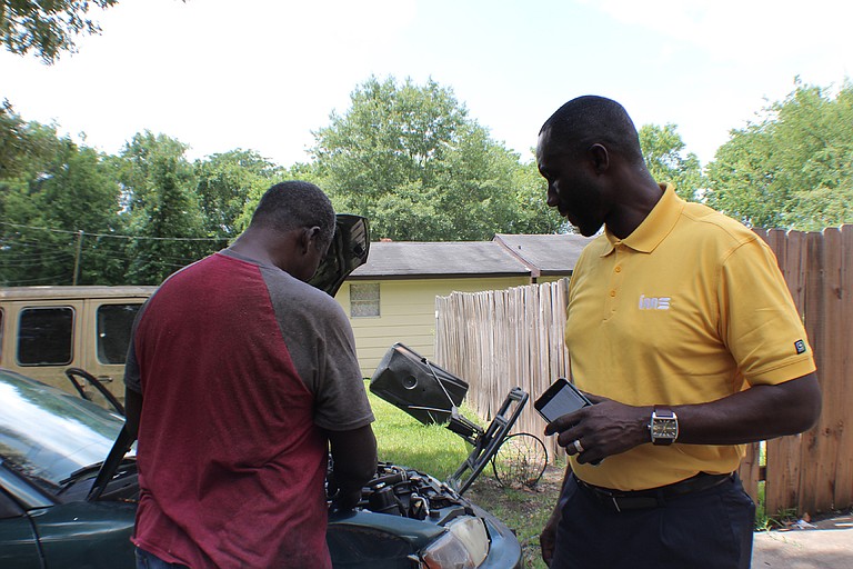 Mayor Tony Yarber peeks under the hood of his 1992 Mitsubishi Mighty Max truck that his family still owns in Subdivision 2 in west Jackson. Photo courtesy Eli Bettiga
