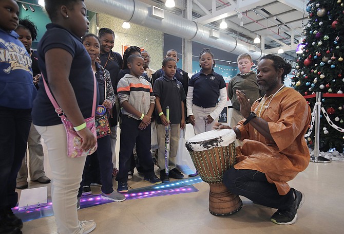 Jerry Jenkins plays an African drum for fourth-grade students at McLaurin Elementary School in Natchez. The Mississippi Alliance of Arts Education funded the drum for the students.