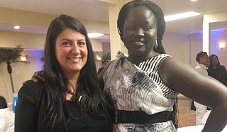 Nina Ghaffari (left) and Akech Garkouth (right) pose at the Emancipation Celebration on Wednesday, Dec. 7; both of them work for the Catholic Charities Unaccompanied Refugee Minor Program in Jackson, and Garkouth is a former refugee minor who went through the program.