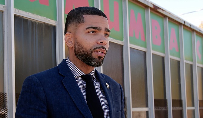 Local attorney Chokwe Antar Lumumba stands in front of the community center on West Capitol Street named after his late father, Mayor Chokwe Lumumba. The son, now running for mayor for the second time, says his slogan is: “When I become mayor, you become mayor.”