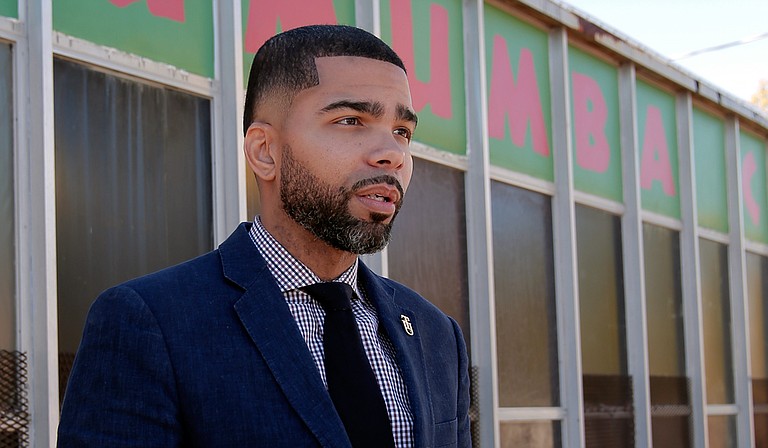 Local attorney Chokwe Antar Lumumba stands in front of the community center on West Capitol Street named after his late father, Mayor Chokwe Lumumba. The son, now running for mayor for the second time, says his slogan is: “When I become mayor, you become mayor.”