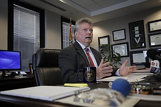 Mississippi Attorney General Jim Hood is suing 25 individuals and companies associated with a prison bribery scheme, saying they should have to repay more than $800 million in revenue they received from the state.