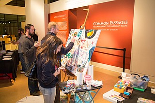 People paint on the community mural at Mississippi Museum of Art’s February Museum After Hours. Photo courtesy Julian Rankin