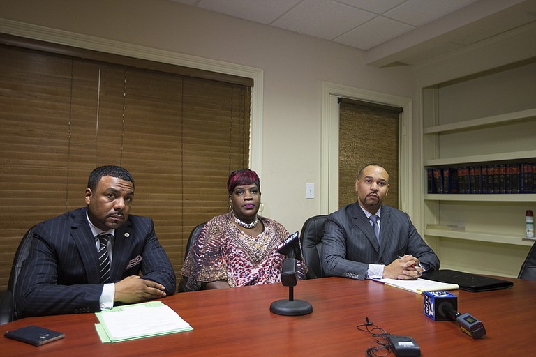 Yvette Mason-Sherman (middle) filed a civil lawsuit against Wayne Parish, the man arrested for killing her son last fall. Charles Tucker (left) and Carlos Moore (right) represent her.