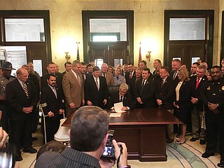 Gov. Phil Bryant signed the "Back the Badge" bill, which makes any crime against a police officer subject to the state's hate crime language.